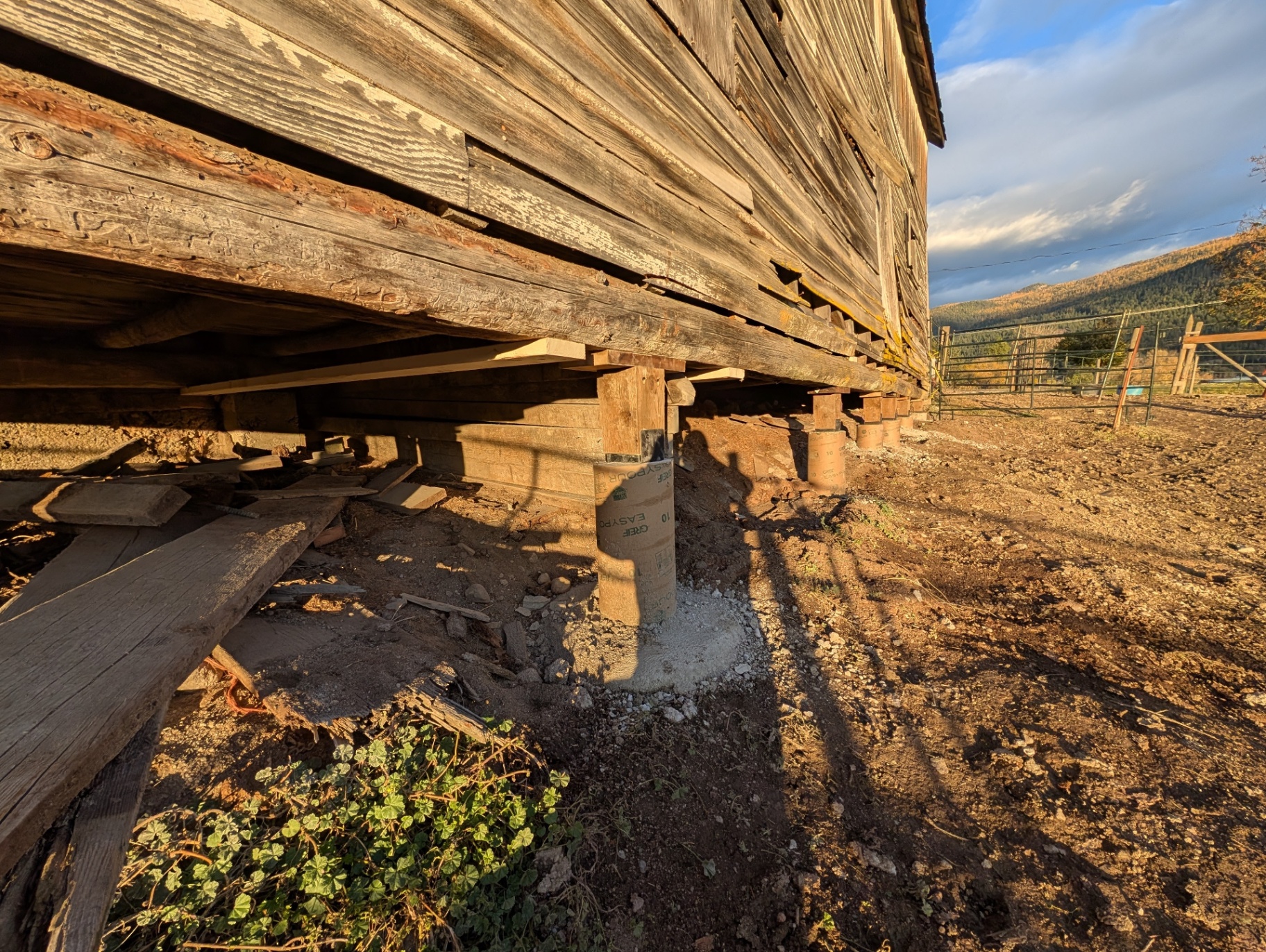 New barn foundation posts installed near Armstrong