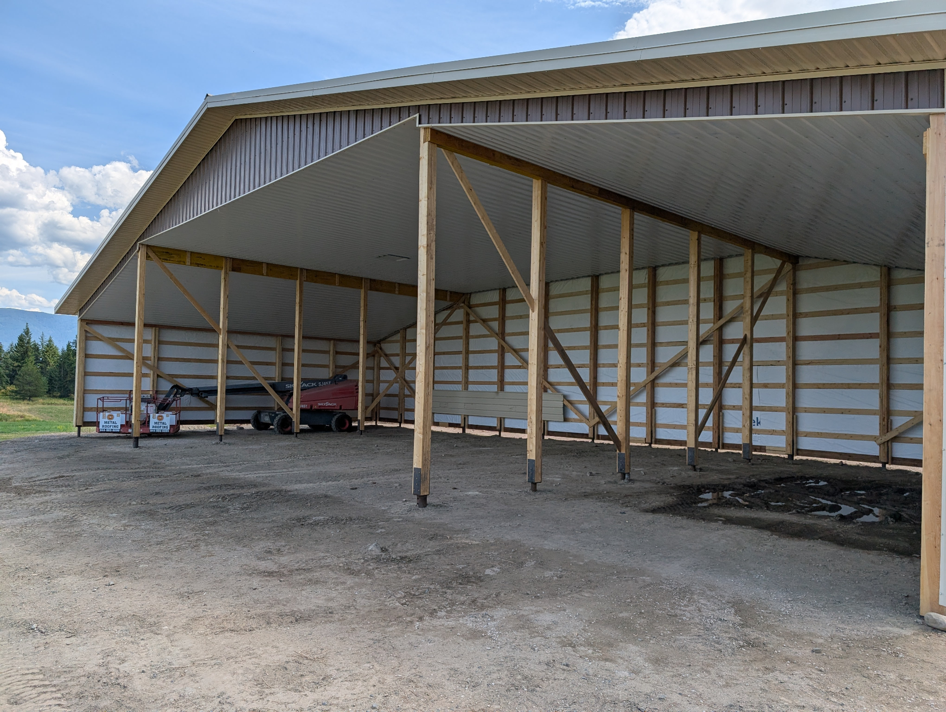 Open-front 80x40 machine shed with brown metal siding and post frame construction near Armstrong BC