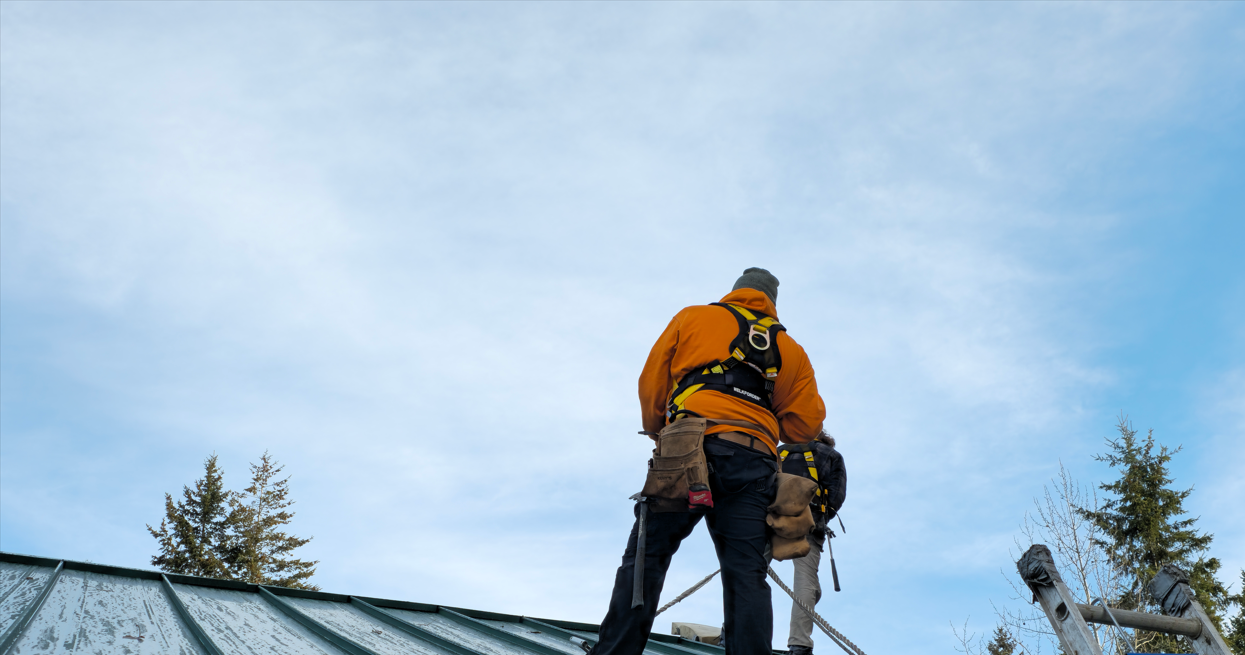 Farrow Built crew inspecting an outbuilding roof in British Columbia