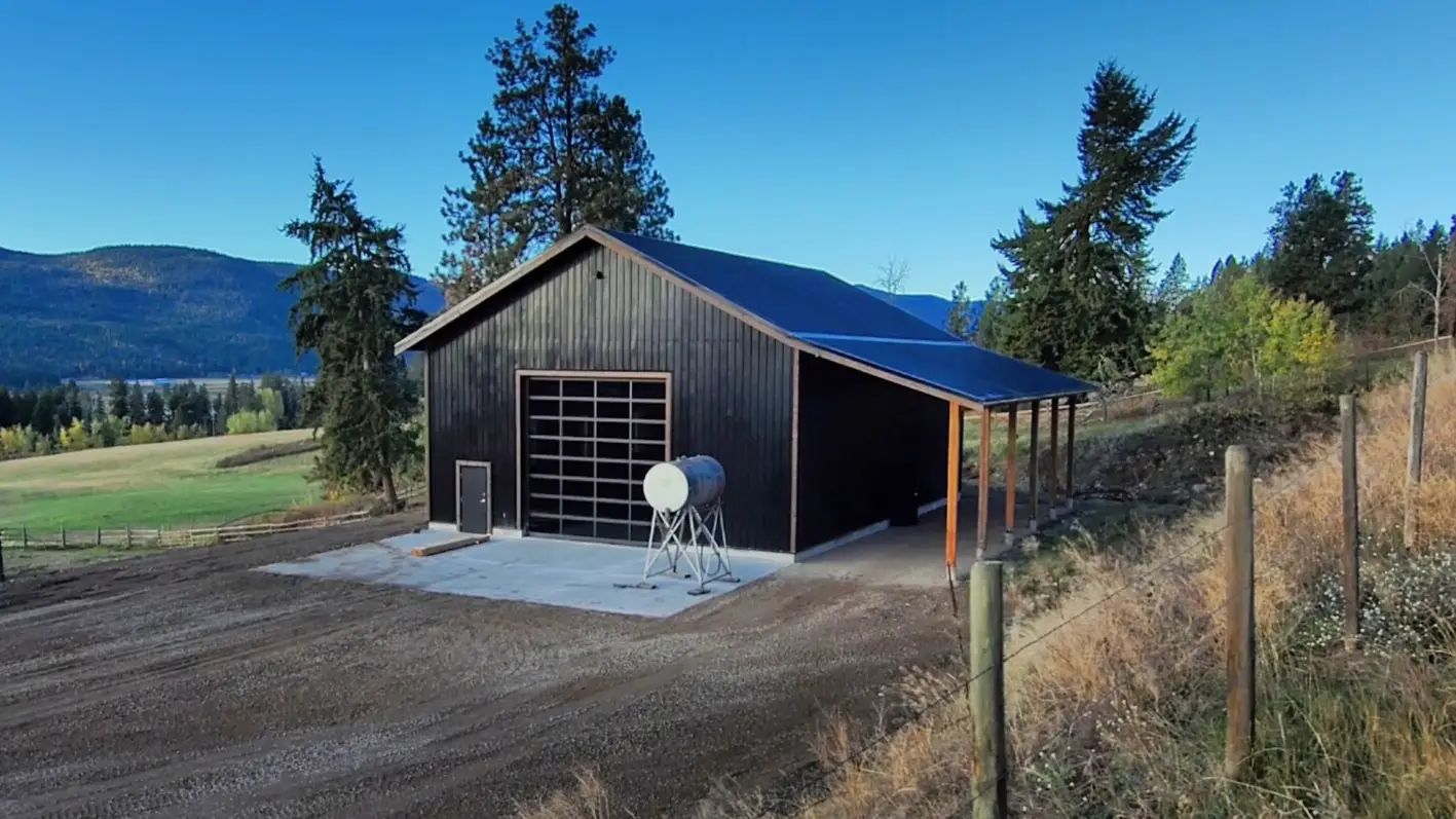 Stick built shop with symmetrical roof and post wrap