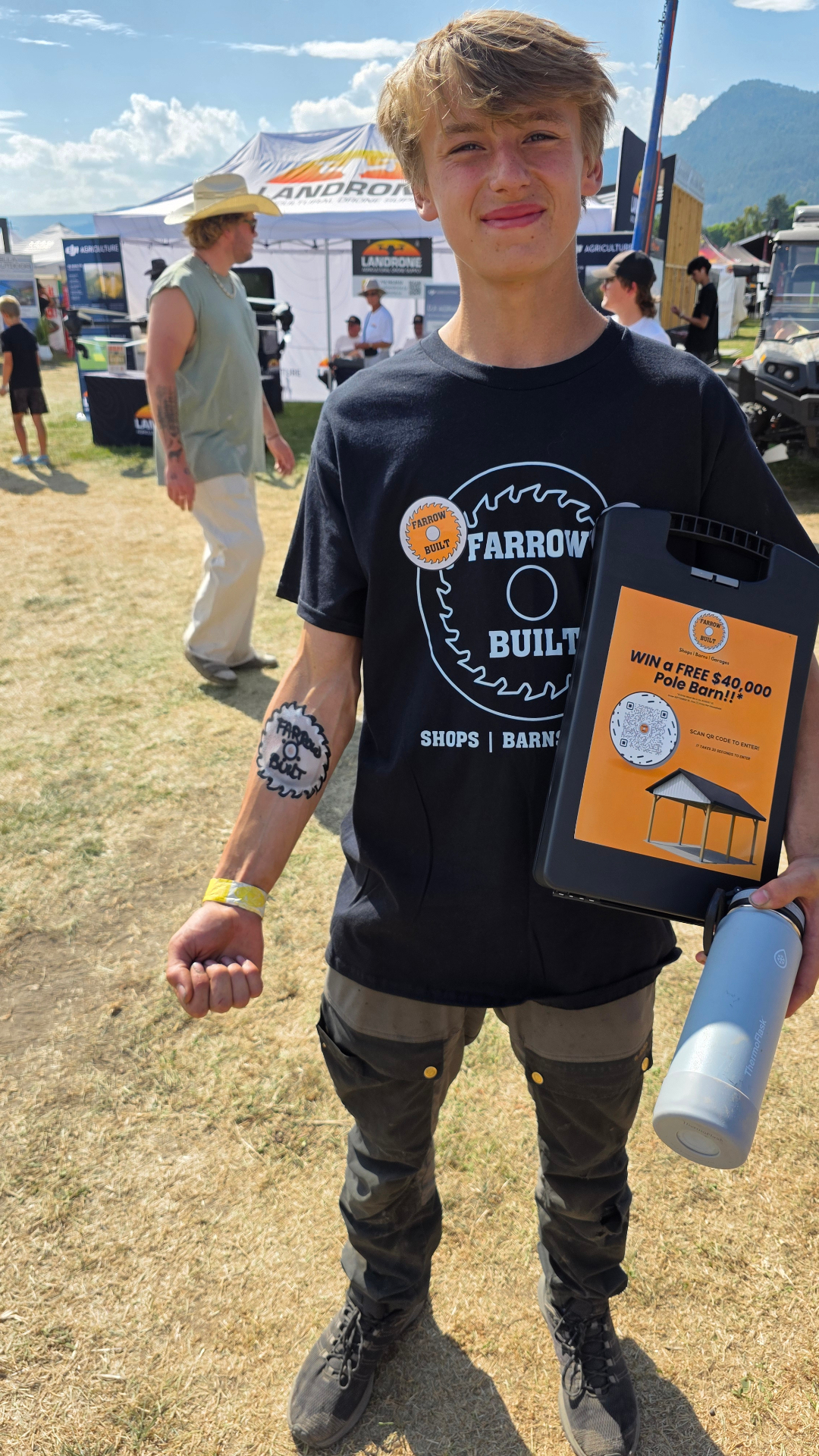 Farrow Built team member managing booth operations at industry event